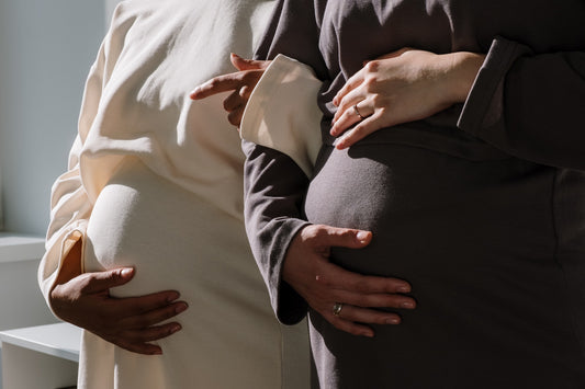 Pregnant friends holding bellies