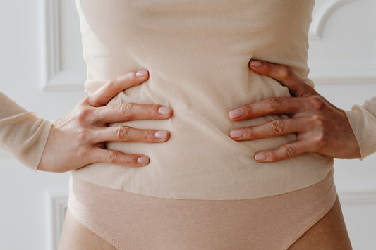 Woman-standing-with-hands-on-stomach