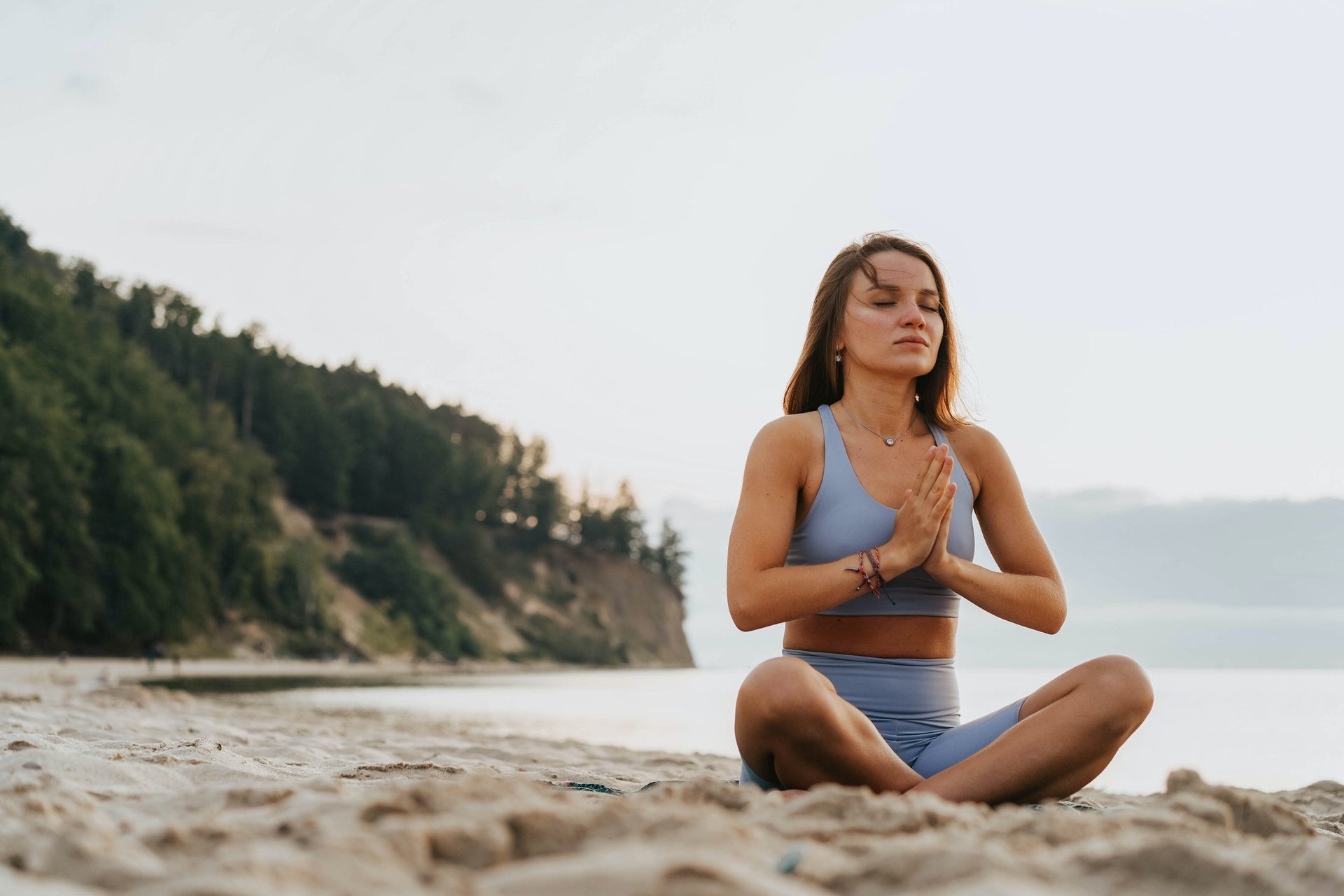 Girl-meditating-on-beach