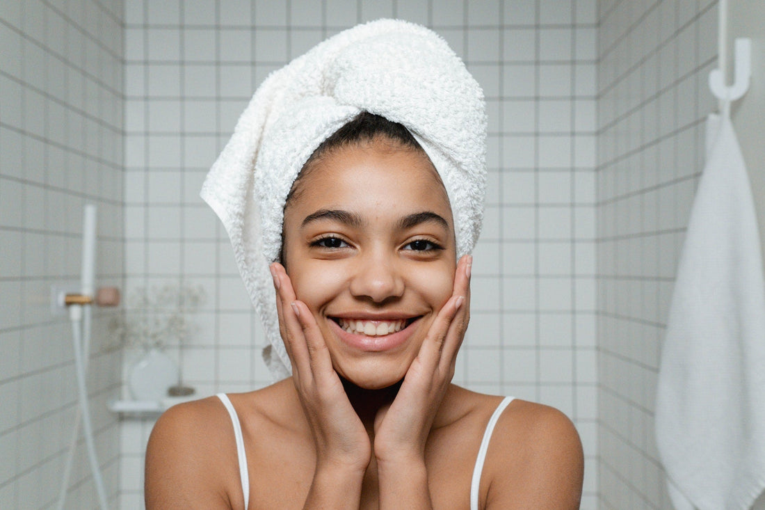 Happy-girl-holding-face-with-clear-skin